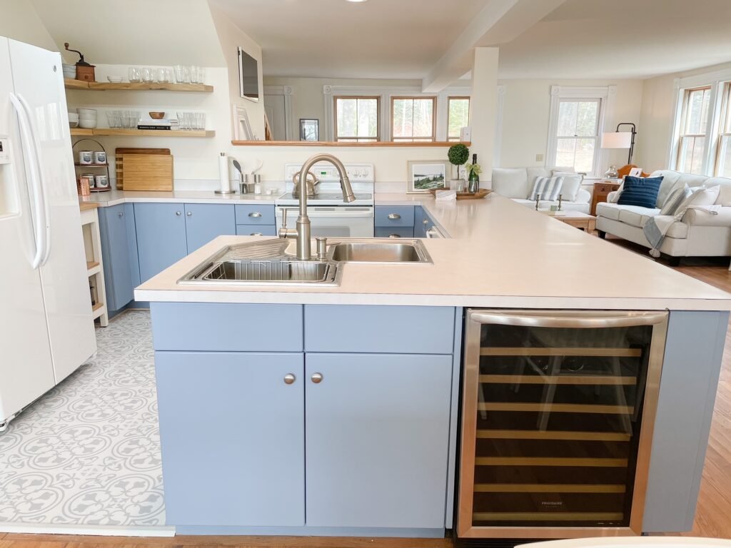 A side view of the cornerstone blue and white kitchen, showing the entrance by the island and clean blue lines of the cabinets
