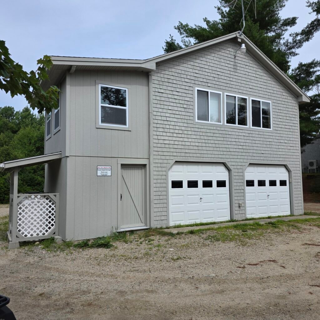 A light gray apartment/garage complex